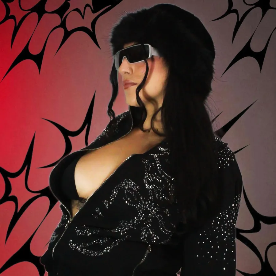 Portrait in dark glasses against a red and black star-print backdrop