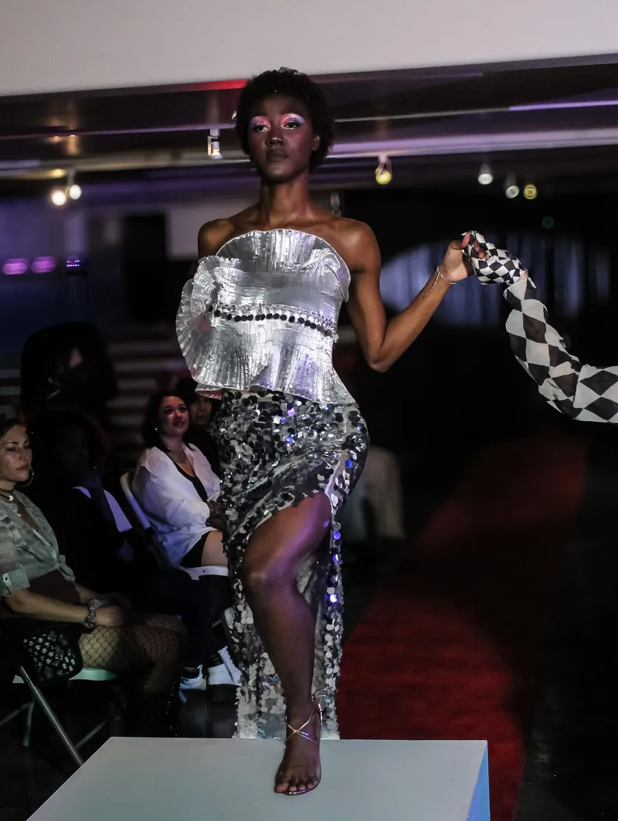 Runway look in a silver sequin dress