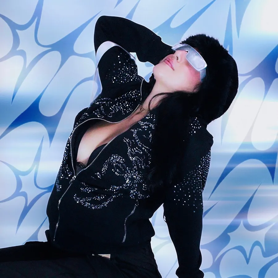 Portrait reclining in futuristic sunglasses against liquid chrome graphics