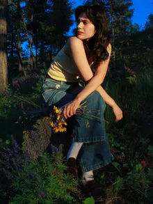 Crouched portrait among wildflowers at dusk