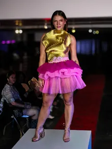 Runway look in a gold top and pink tutu
