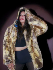 Portrait in a fur coat under violet light