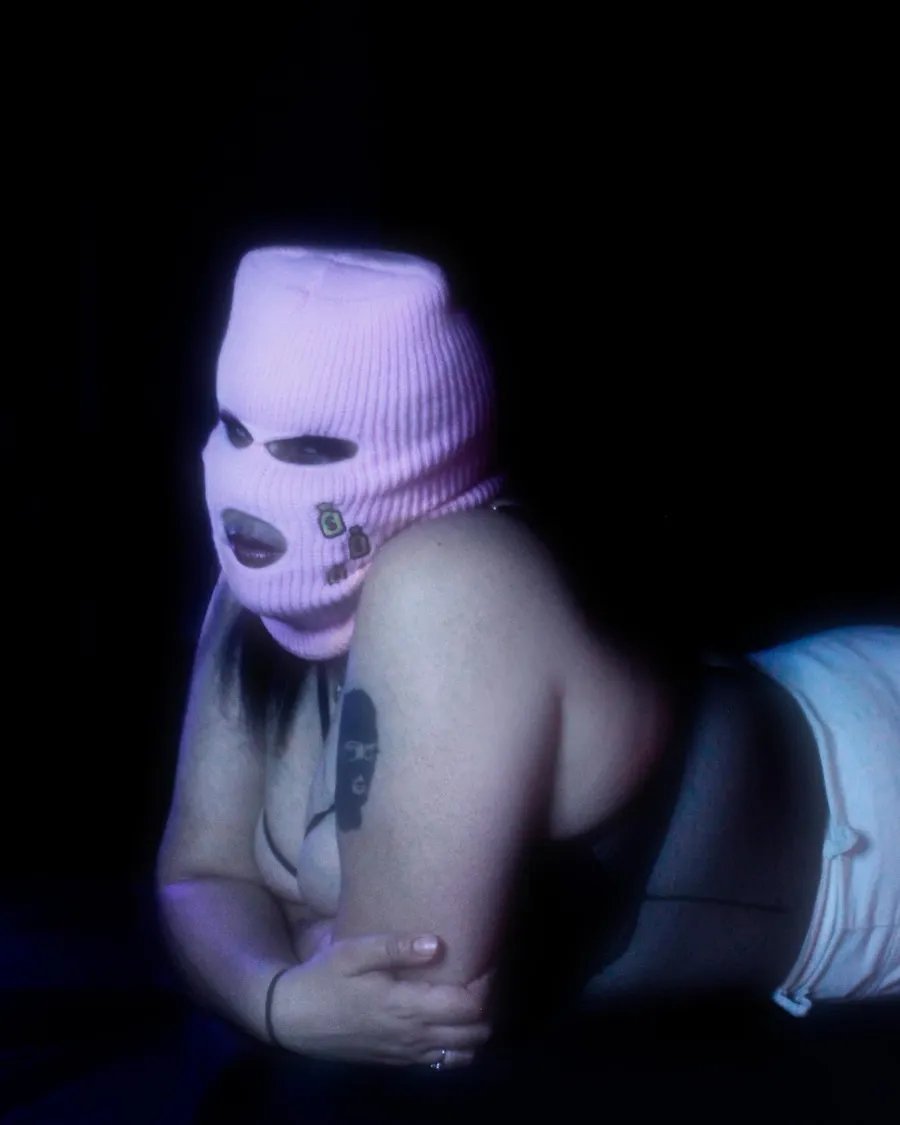 Portrait in a lilac ski mask, low light