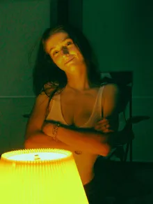 Portrait beside a glowing lamp in a green room
