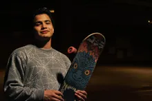 Portrait holding a skateboard in a parking garage