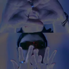 Inverted-color still, hands raised