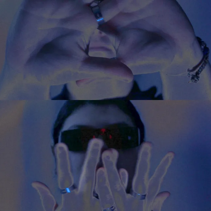 Inverted-color still, hands raised